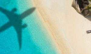 Shadow of an approaching plane as it lands on a tropical island.