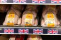 Packed whole chickens line the shelves of a UK supermarket.