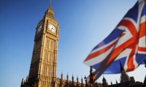 UK flag flies infront of Big Ben clock tower.