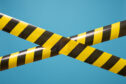 Black and yellow tape stretched across a pale blue background.