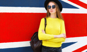 Model poses against union jack backdrop.