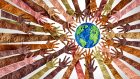 A circle of hands in different skin tones reaching towards the Earth.