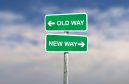 Road signs signal a choice between 'old way' and 'new way'.