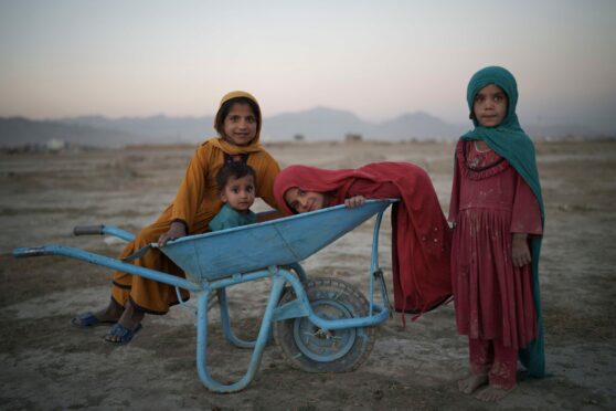 Children of families forced to flee their homes play in a camp for displaced people in Kabul