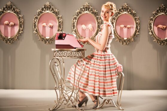 Deborah Francois with a typewriter in the 2012 film Populaire, a romantic comedy about a 1950s secretary