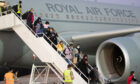 Over 100 Afghans arriving in the UK after being airlifted out of an unnamed third country by the RAF