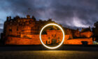 The Scottish Government's glowing zero light illuminating Edinburgh Castle.