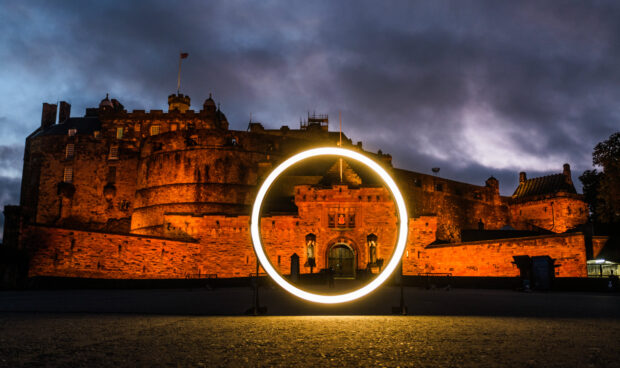 The Scottish Government's glowing zero light illuminating Edinburgh Castle.