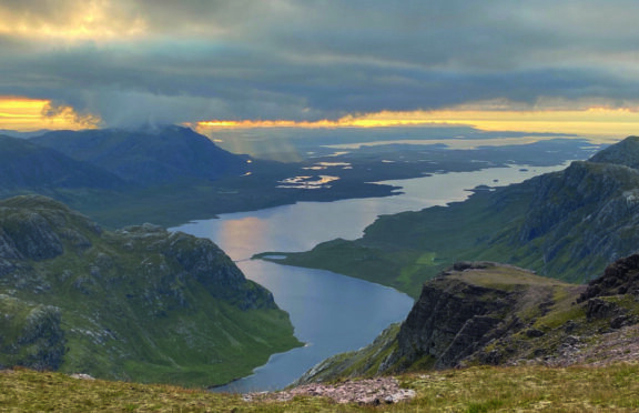 The sun begins to set over remote A’ Mhaighdean in the north-west Highlands