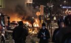 Cars are set alight as protests against Covid lockdown restrictions turn violent in Rotterdam, Netherlands on Friday. At least seven people are injured as police struggle to get rioting under control