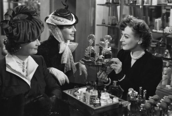 Phyllis Povah and Rosalind Russell pick a perfume, guided by store assistant Joan Crawford, right, in 1939 movie The Women