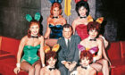 Playboy dated circa 1960 of their founder Hugh Hefner with some Playboy bunnies.