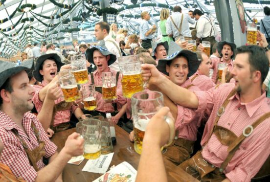 Visitors to the annual beer festival 'Oktoberfest' celebrate in Munich