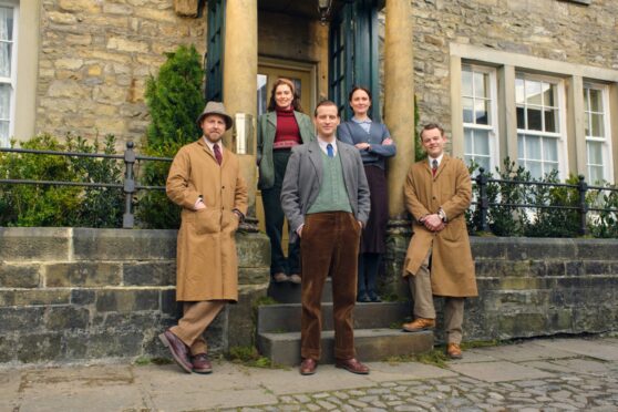 Nicholas Ralph, centre, as vet James Herriot in Grassington, which doubles as fictional Darrowby, with All Creatures co-stars.