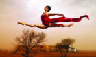 Ballet star Leanne Benjamin takes flight above a road train in Alice Springs in her native Australia in 2006