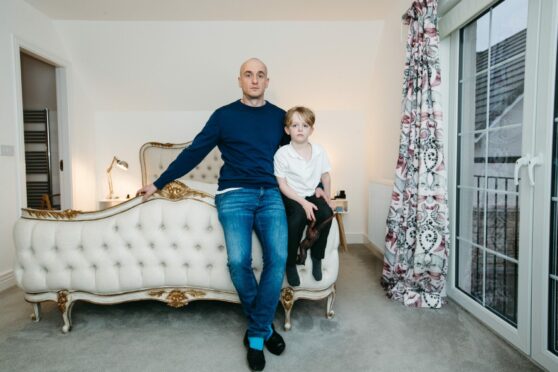 Kris Jakobsen and son Charlie in the master bedroom of their Bonnyrigg home.