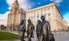 A bronze statue of the four Liverpool Beatles stands on Liverpool Waterfront, .