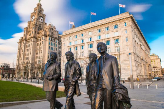 A bronze statue of the four Liverpool Beatles stands on Liverpool Waterfront, .