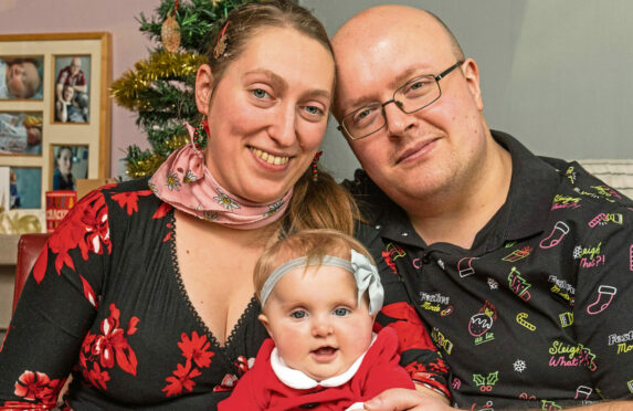 Mum Margaret and dad Richard with baby Isabella ready for their first Christmas together in their home in Archiestown near Aberlour Moray.