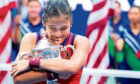 Emma Raducanu hugs the US                       Open trophy after winning the final in September.