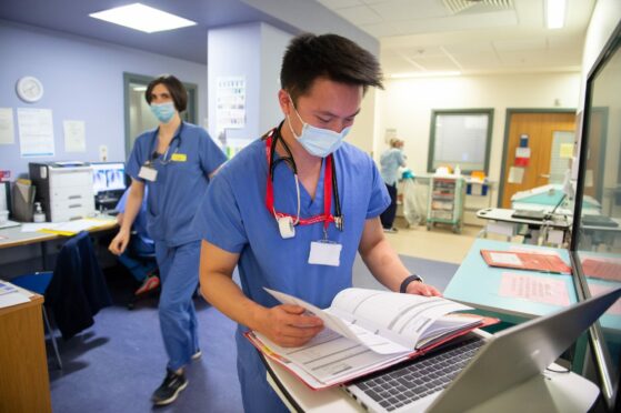Medical staff check patients’ notes at the Acute Receiving Unit at the Queen Elizabeth University Hospital, Glasgow, in January as another              variant spread quickly