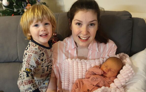 Lucy Lintott with son LJ and new baby daughter at home in in Elgin