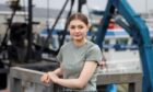 Abbie Jones, at Peterhead harbour, is among  students hailing the Open University.