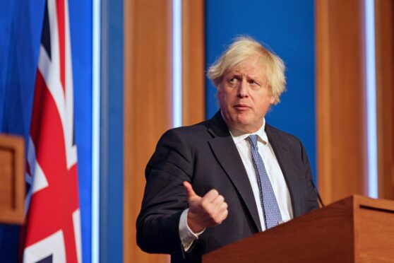 PM Boris Johnson announces new Covid restrictions at a press conference on Wednesday but scandal over No 10’s Christmas parties last year refuses 
to go away