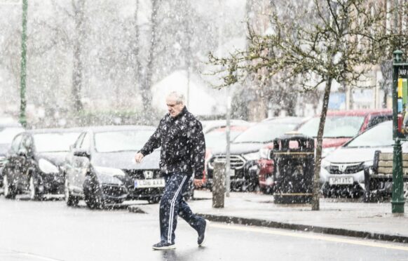 Sleet and snow fall in Biggar town centre, South Lanarkshire as Storm Barra hits the UK and Ireland with disruptive winds, heavy rain and snow on Tuesday.
