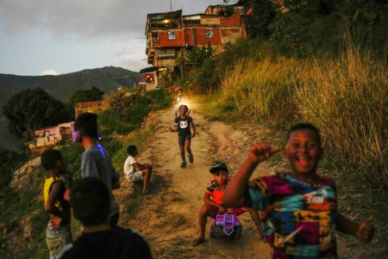 Children play on the edge of a barrio in the Catia area of Caracas, Venezuela’s capital