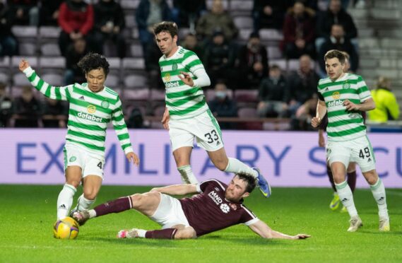 John Souttar slides in to tackle Celtic’s Reo Hatate in midweek. But will a deal be reached for him to exit Tynecastle early to move to Rangers, in similar fashion as Tony Watt departing Motherwell to join Dundee United?