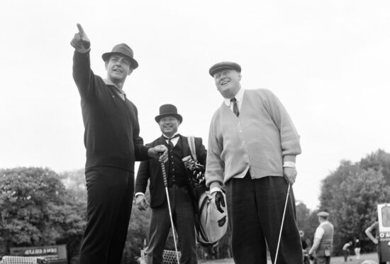 Sean Connery, Harold Sakata and Gert Frobe as Bond, Oddjob and Goldfinger on the set of the 1964 movie of Ian Fleming’s novel, Goldfinger.