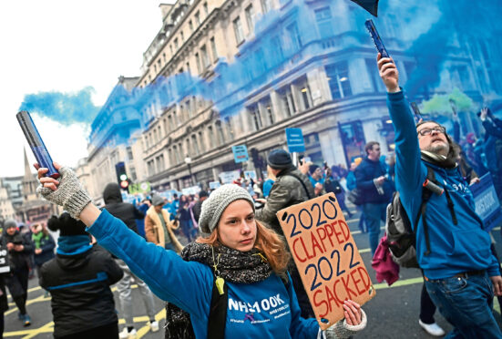NHS workers protest against mandatory Covid-19 vaccinations during a march in London yesterday