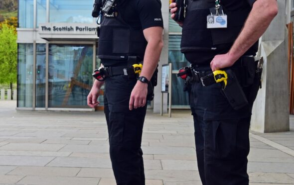 Police Scotland officers armed with tasers at the Scottish Parliament, 
Edinburgh.