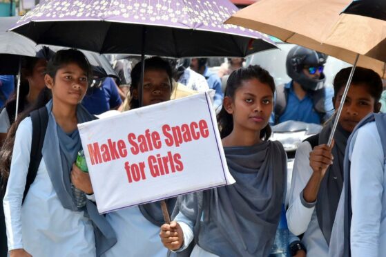 Young people hold placards and participate in a silent protest rally against the rape and murder of a teenage girl in Ranchi, in the eastern Indian state of Jharkhan in 2018