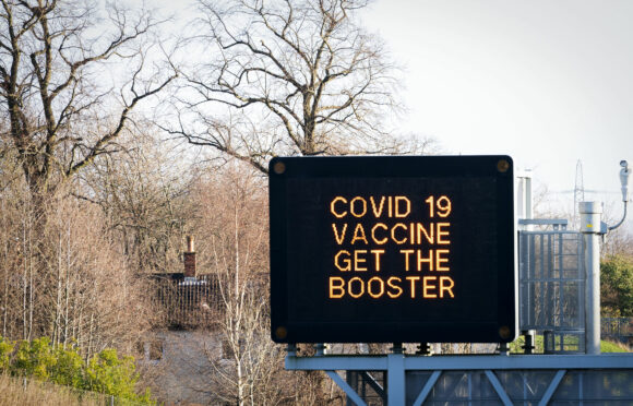 Information signs above the M8 motorway in Glasgow read 'Covid 19 Vaccine Get the Booster', as the coronavirus booster programme continues across the UK