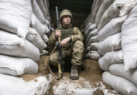 A Ukrainian soldier in a trench in the Donetsk region.