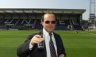 Giovanni di Stefano raises a glass on the pitch at Dens Park, shortly after joining the board of Dundee in 2003.