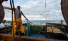 A crew member pulls up the nets on a fishing trawler in the North Sea but the cost of exporting the catch has soared