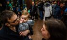 Sergei, Katya and daughter Naomi seek shelter on the platform of the metro subway in Kharkiv, Ukraine as Russian troops invade the country on Thursday