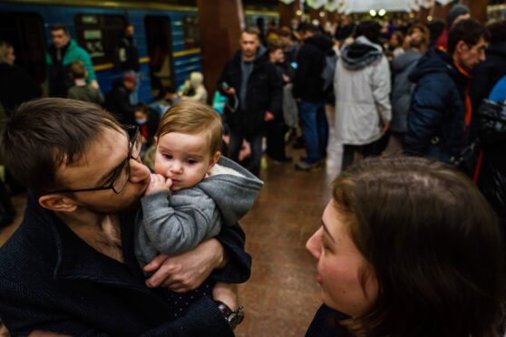Sergei, Katya and daughter Naomi seek shelter on the platform of the metro subway in Kharkiv, Ukraine as Russian troops invade the country on Thursday
