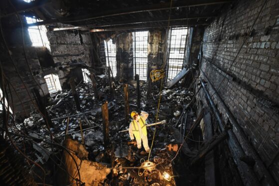 Forensic experts sift through the ashes of the library after the first blaze at Glasgow School of Art in 2014