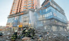 Ukrainian firefighters put out the fire on a high-rise apartment block which was hit by shelling in Kiev, Ukraine, 26 February 2022.