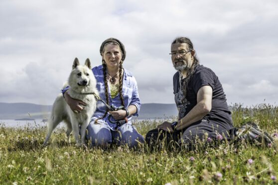 Helen Hart and Jason Tilbury with pet dog on their croft on the Shetland island of Yell