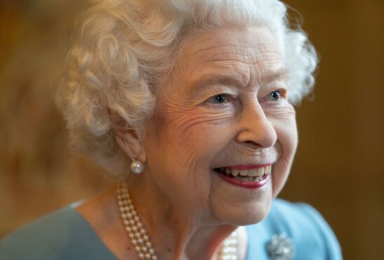 The Queen in the Ballroom of Sandringham House speaks with members of the local community yesterday as she marks the start of her Platinum Jubilee celebrating the day, 70 years ago today, when she ascended to the throne