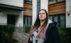 Ria Lewis outside her flat in Colonsay View, Edinburgh. Lewis is unable to sell as the flat is said to have unsafe cladding needing to be replaced