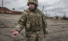 Ukraine soldier shows shell fragment from an attack