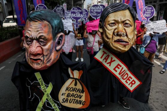 Protesters in Manila appear as outgoing Philippines leader Rodrigo Duterte and presidential candidate Bongbong Marcos Jr