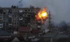 An explosion is seen in an apartment building after Russian's army tank fires in Mariupol, Ukraine.