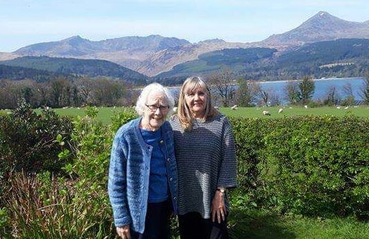 Maggie McEachern in her garden on Arran with mother Ann. Ann has missed vital cancer medication being delivered on time due to ferry disruption.